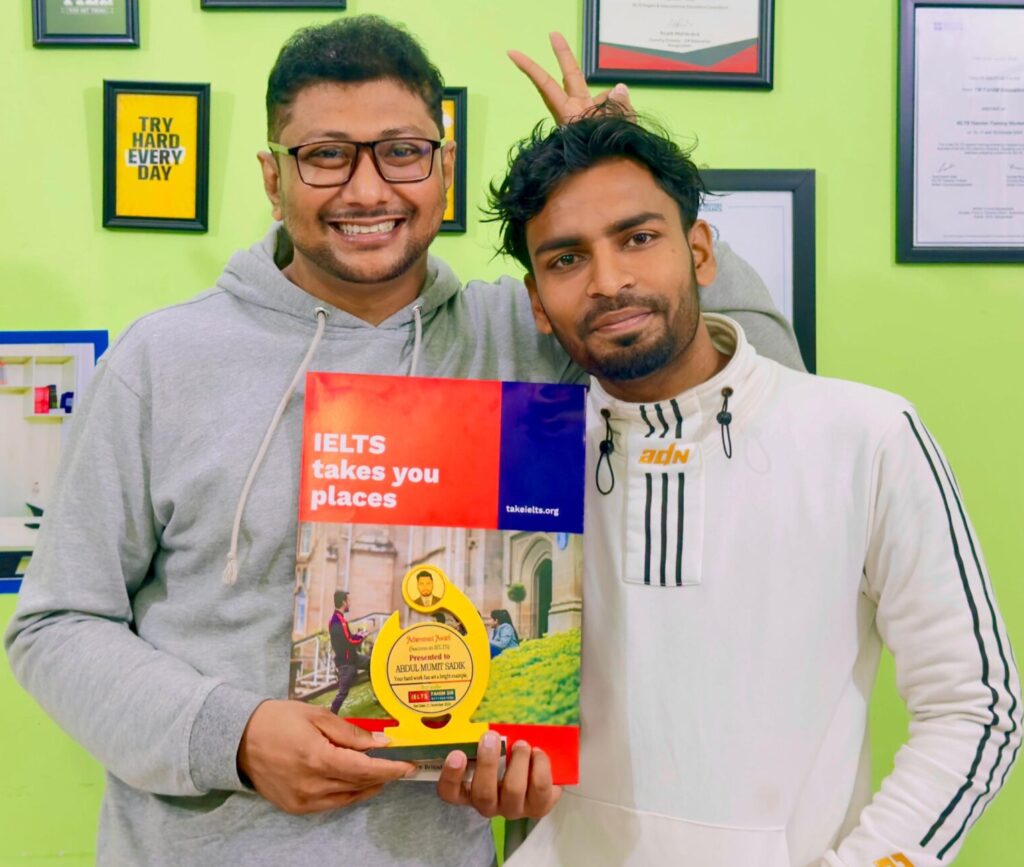 A joyous and proud student, Abdul Mumith Sadik, smiling with his official IELTS score report, celebrating the successful completion of his dedicated study journey.