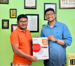 Abdul Munayem Ruhel, a high school teacher, is beaming with pride while holding his IELTS certificate. The photo captures his triumphant success after balancing a full-time job and dedicated study in Kulaura, Bangladesh.