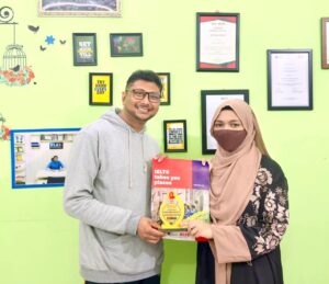 A proud moment for Antara Sabeeha Chowdhury, a student holding a certificate and smiling. She recently scored a Band 7 on her IELTS exam.